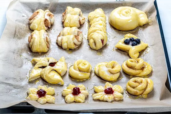 Baking tray with homemade buns ready for baking