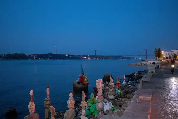 Balanced stone towers and 25 de Abril bridge