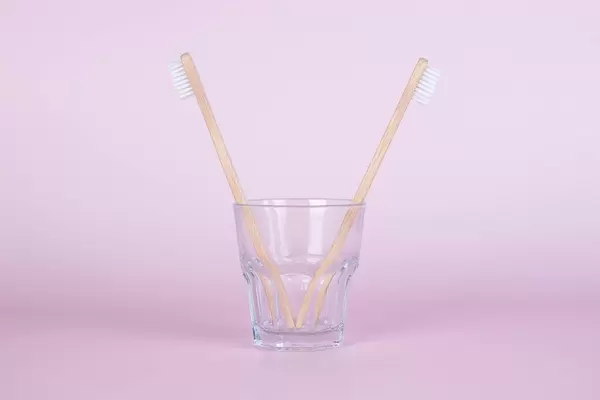 Bamboo toothbrushes in a glass