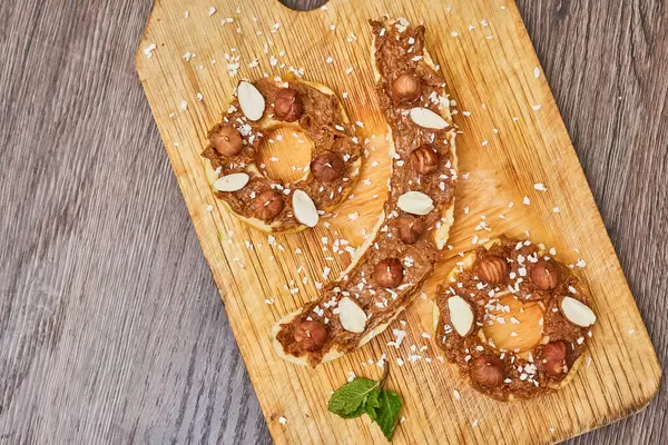 Banana and apple cuts covered with peanut paste