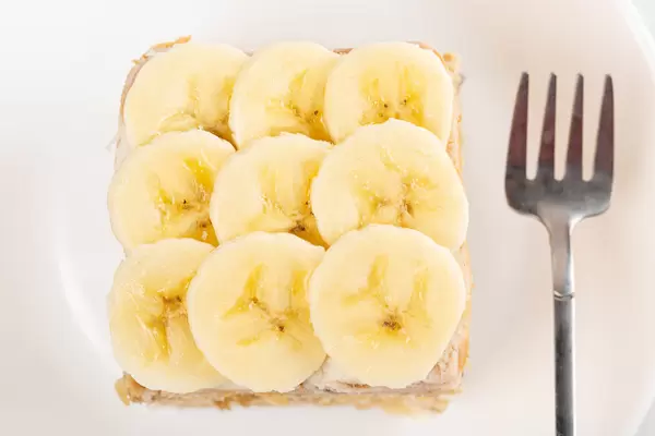 Banana cake on a white plate, top view