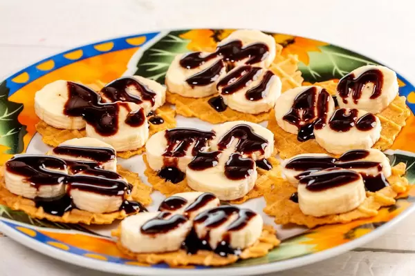 Banana waffle with chocolate on plate (Flip 2019)
