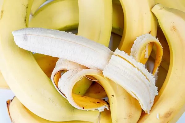 Bananas background with peel and peeled (Flip 2020)