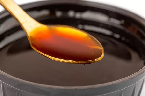 Barbecue sauce in a spoon close-up