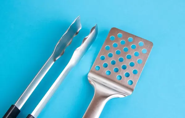 Barbecue tools on blue background