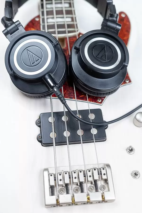 Bass Guitar Bridge with Studio Headphones on the guitar