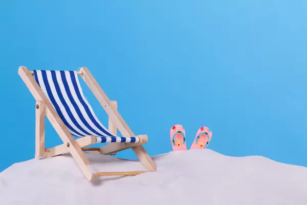 Beach chair and flip flops on the beach