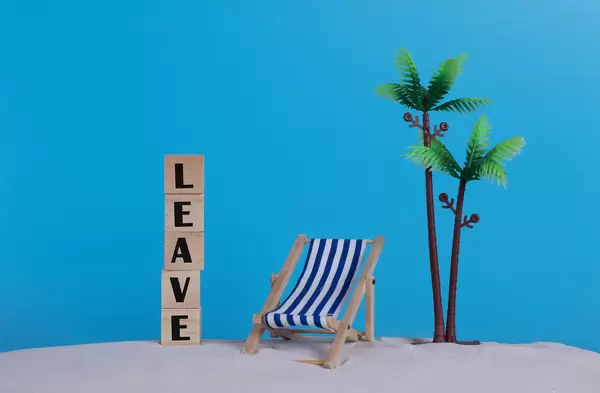 Beach chair and wooden blocks with Leave text