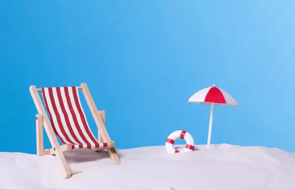 Beach chair with beach umbrella on blue background