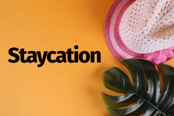 Beach hat with tropical monstera leaf and Staycation text