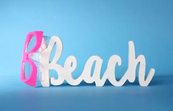 Beach text with diving mask on blue background