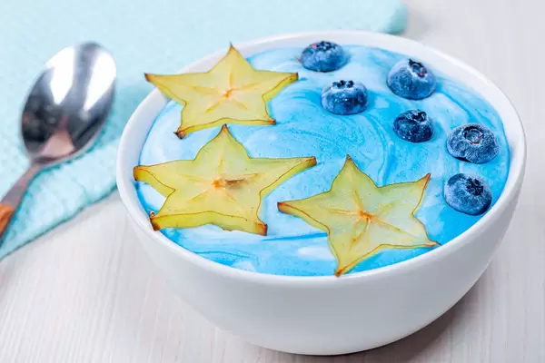 Beautiful and healthy Breakfast-oatmeal with carambola and blueberries with blue yogurt (Flip 2019)