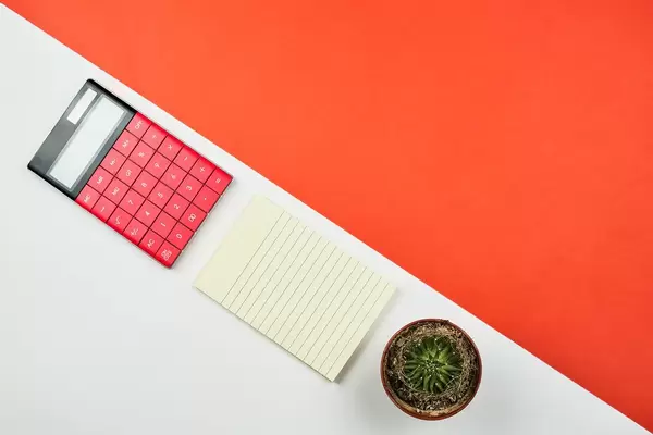 Beautiful arrangement of office supplies on bright split-colored background