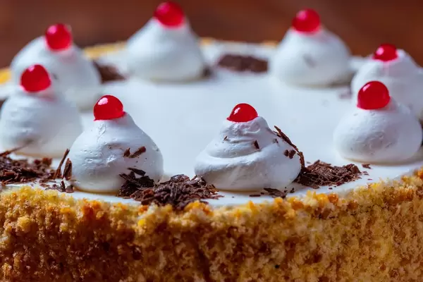 Beautiful birthday cake with white cream close up