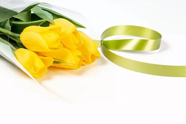 Beautiful bouquet of yellow tulips on a white background