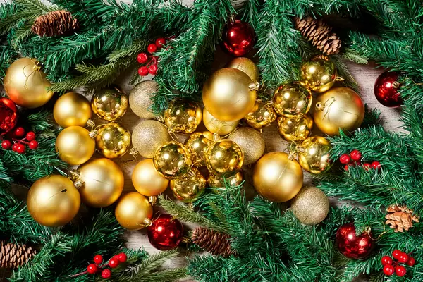 Beautiful Christmas background made of fir tree branches and golden colored baubles