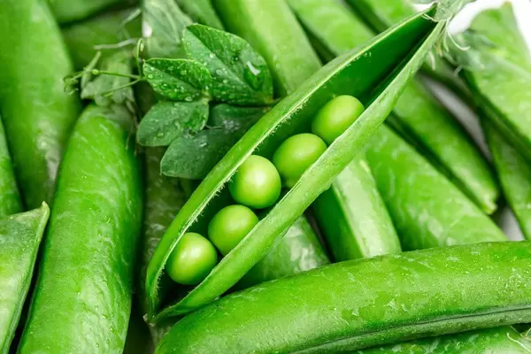 Beautiful close up of green fresh peas and pea pods. Healthy food