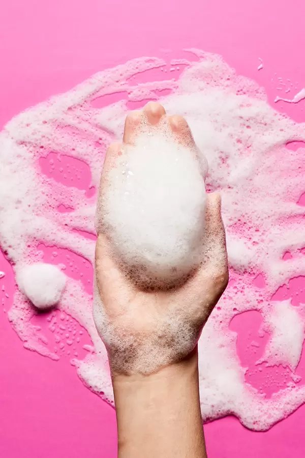 Beauty foam in hand of woman