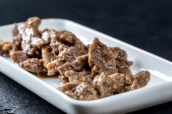 Beef stewed in red wine and yogurt with herbs