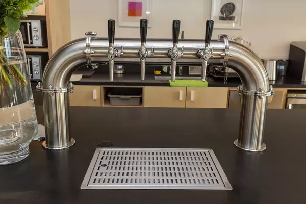 Beer dispenser in a shared kitchen at German WeWork rental office and co-working area at Friesenstraße in Cologne