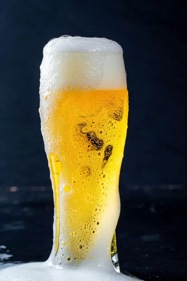 Beer pours through the top of the glass