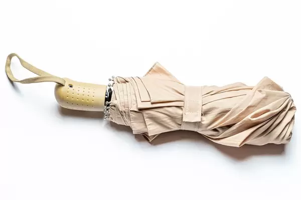 Beige umbrella on a white background, top view (Flip 2020)