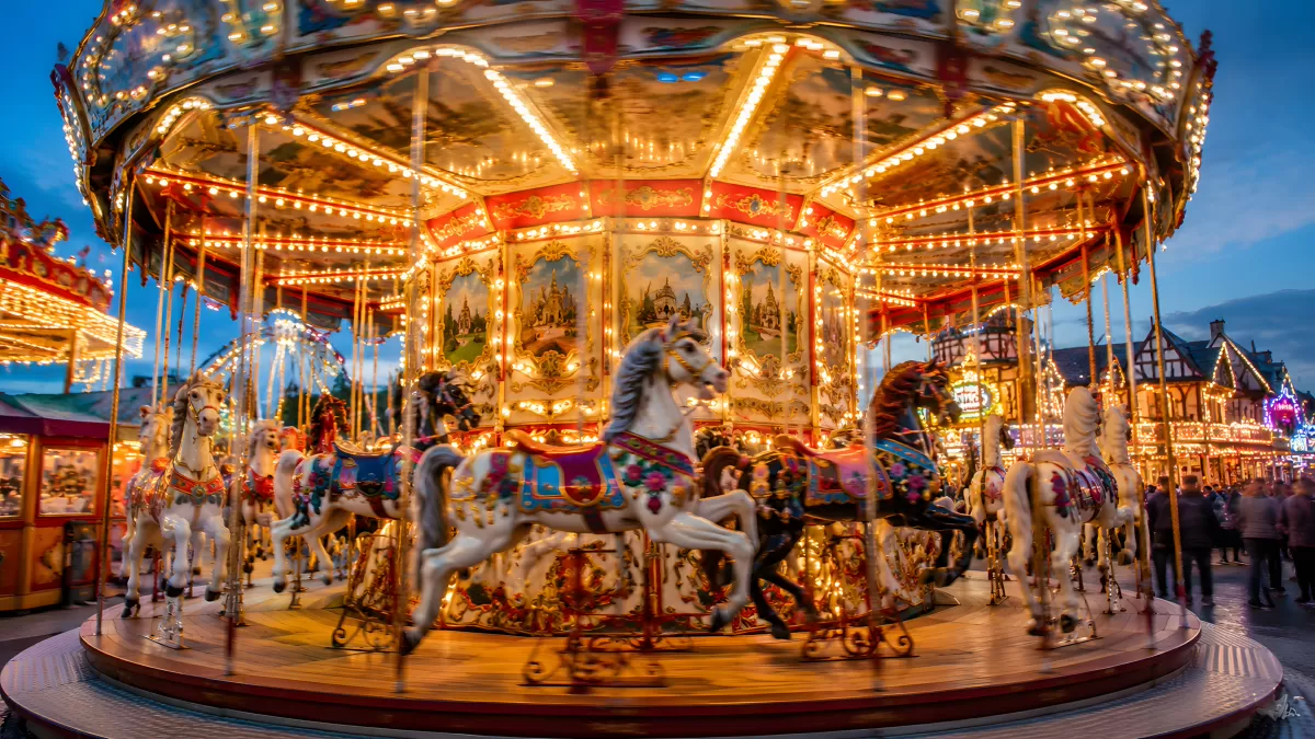 Beleuchtetes Karussell auf einem Jahrmarkt bei Nacht