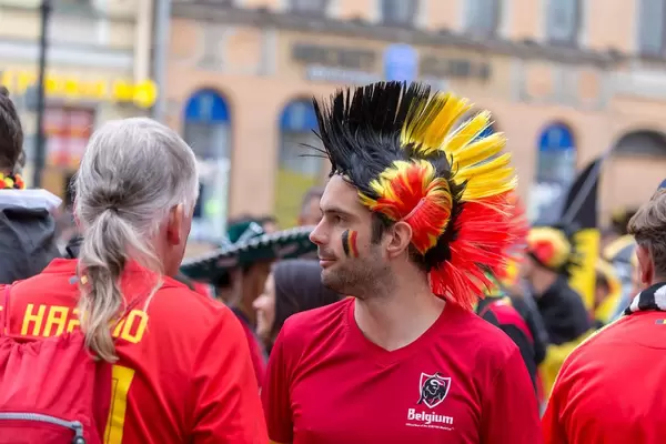 Belgian soccer fan with mohawk haircut dyed in national colors