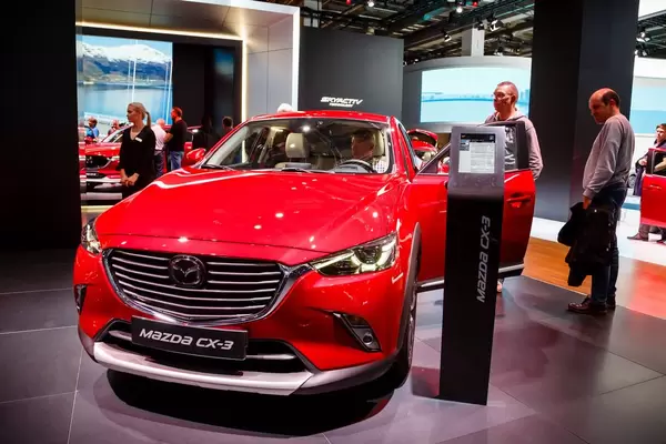 Besucher schauen sich das Mazda MX-3 Modell an