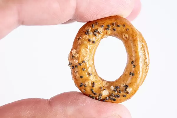 Bezer with poppy seed in the hand above white background