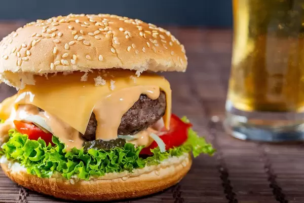 Big Burger and a glass of beer behind.