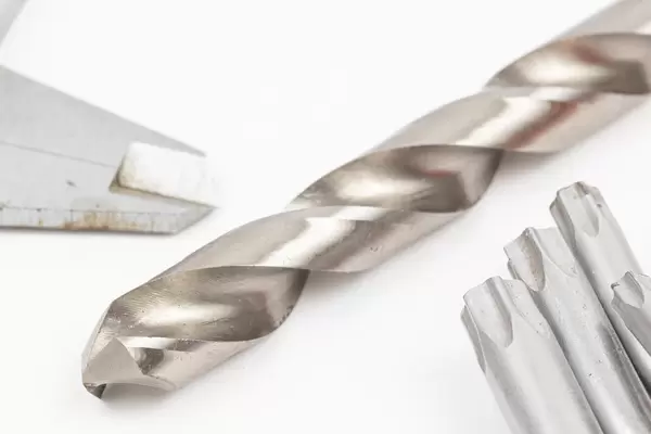 Big Metal Drill with tools isolated above white background