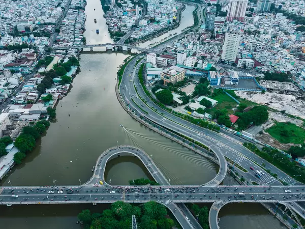 Bird View Drone Photo of a Traffic Jam on a Multi Level Bridge over Saigon River with many Motorbikes and Cars in Ho Chi Minh City, Vietnam