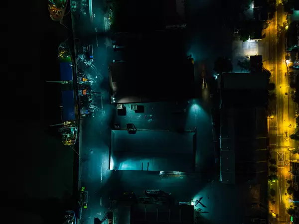 Bird View Night Drone Shot of Khanh Hoi Nha Rong Port with Transport Ships and Storage Halls in Ho Chi Minh City, Vietnam