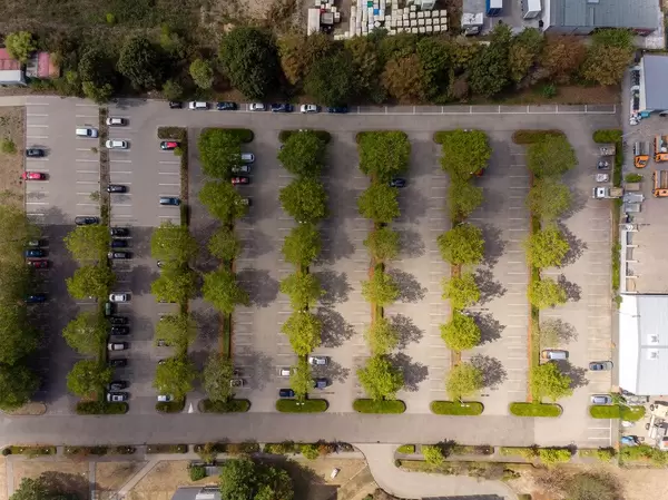 Bird's eye view of a parking lot with trees