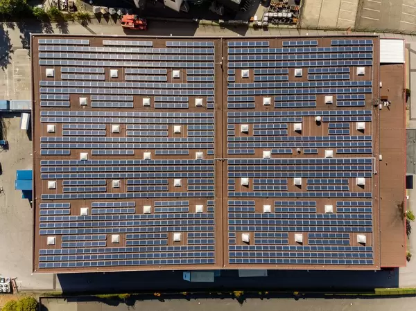 Bird's eye view of solar panels on the roof of an industrial building