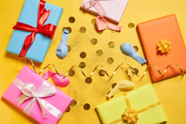 Birthday gifts on yellow background