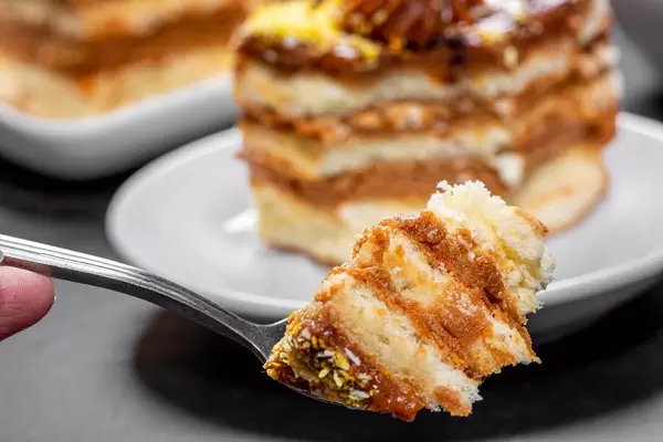 Biscuit cake with boiled condensed milk with fork