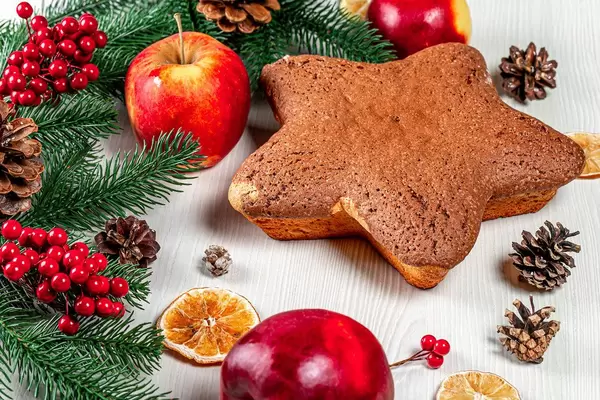 Biscuit in form star on the table with apples, dried citrus and Christmas decor (Flip 2019)