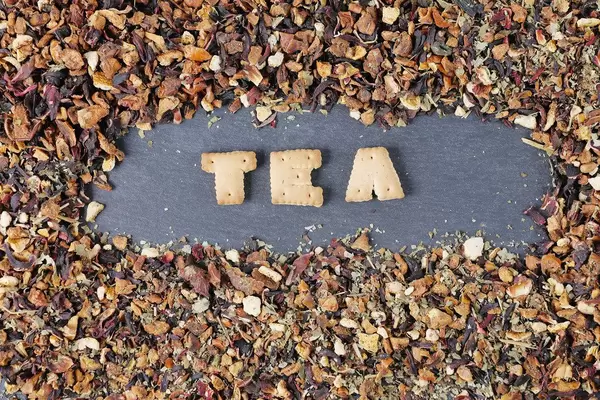 Biscuit letters, Tea, among dry tea leaves