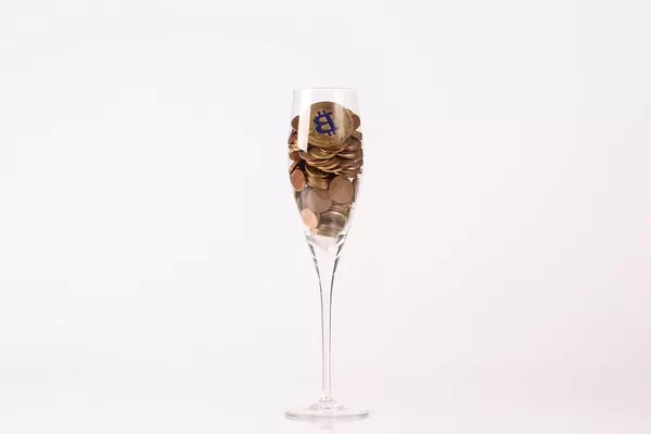 Bitcoin and coins in champagne glass (Flip 2019)