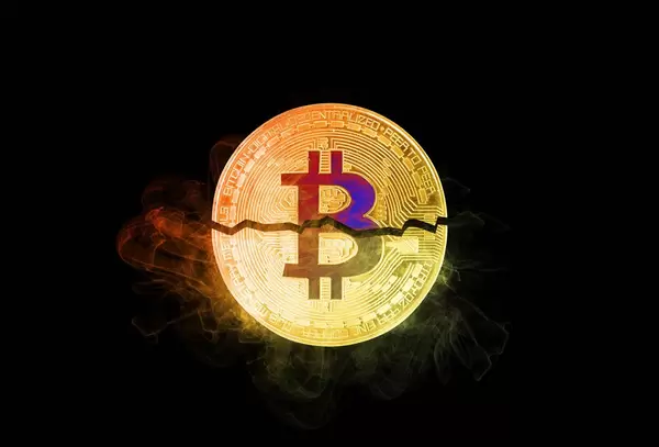 Bitcoin broken in half on black background