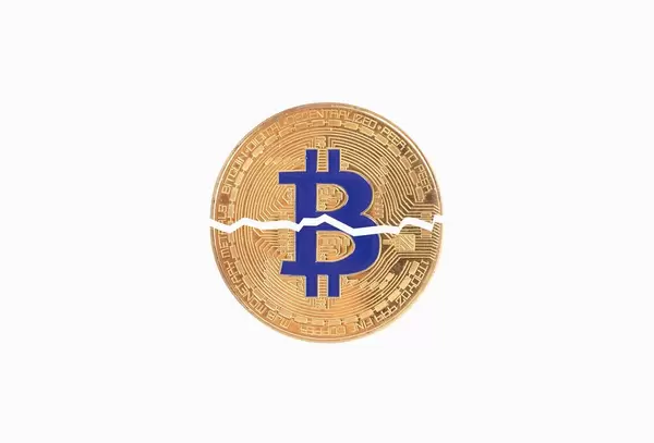 Bitcoin broken in half on white background