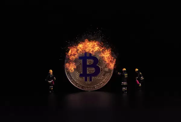 Bitcoin on fire and miniature firefighters