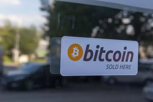 Bitcoin sold here sticker on a shop window