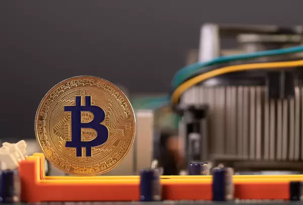 Bitcoin symbol coin on computer parts background