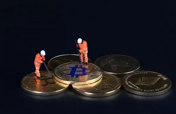 Bitcoins and miners on a black backgrund