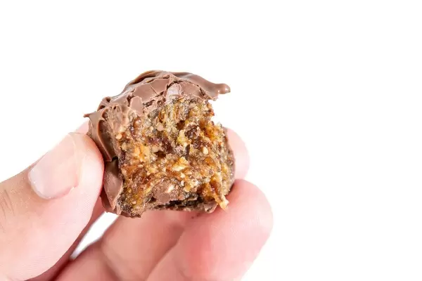 Biten Energy Balls with Chocolate Glaze in the hand