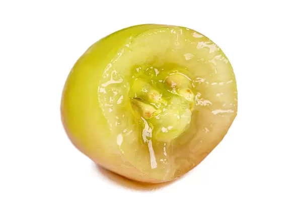 Bitten berry of green grapes, close-up