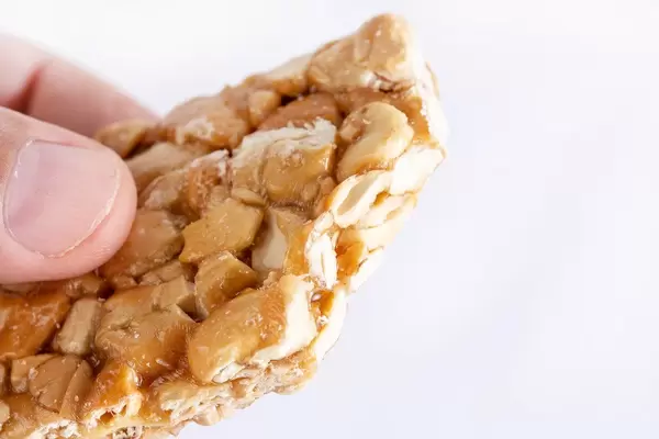 Bitten Cashew Bar in the hand